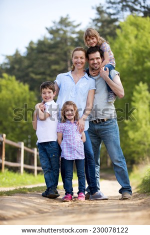 Family with twin girls in the countryside