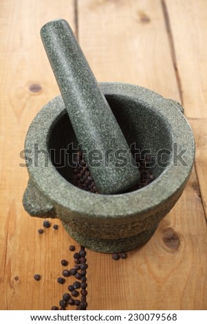 Mortar and pestle with fresh black pepper