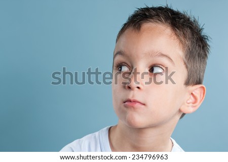Portrait of a boy, distrusting, sideways glance
