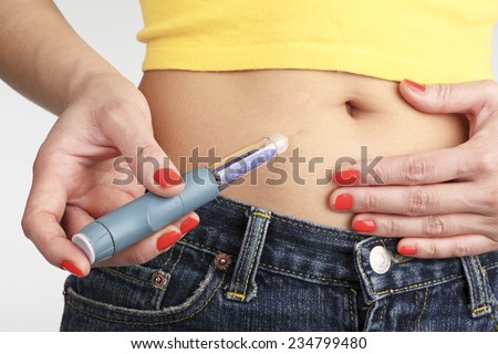 Woman injecting insulin pen