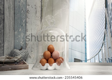 Fresh eggs under bell jar on window sill in city