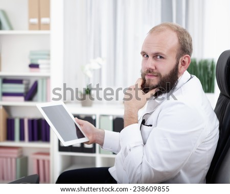 Doctor in practice using digital tablet
