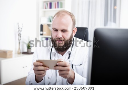 Doctor using smart phone in practice