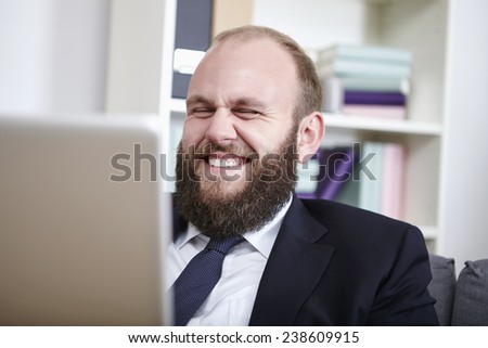 Businessman surfing the net, laughing