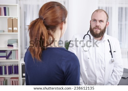 Female patient consulting doctor in practice