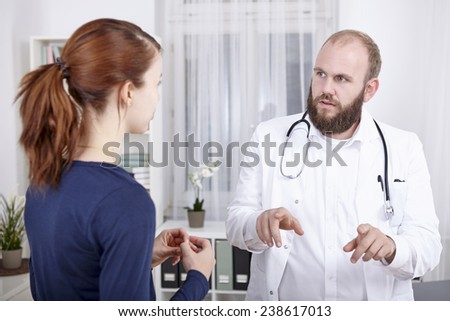 Female patient consulting doctor in practice