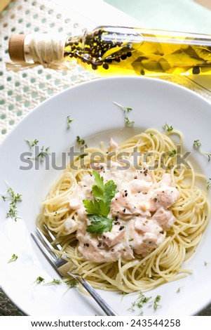 Spaghetti with salmon, mornay sauce and cress on plate, elevated view