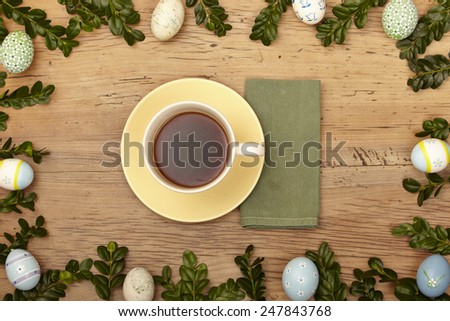 Easter decoration, coffee cup and napkin on wood