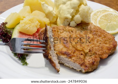 Breaded pork cutlet with boiled potatoes, cauliflower and hollandaise sauce