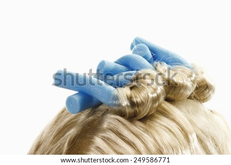 Close up of curlers on blonde wig