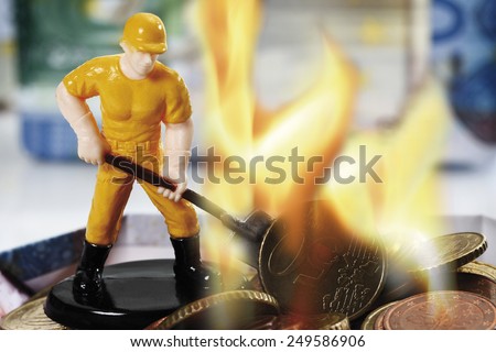 Figurine burning money, close up