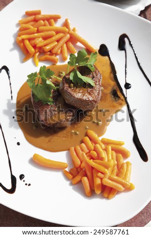 Beef fillet with pepper cream sauce and carrots, potatoes