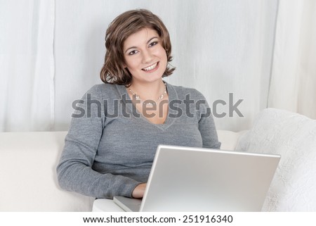 Young woman with laptop on couch
