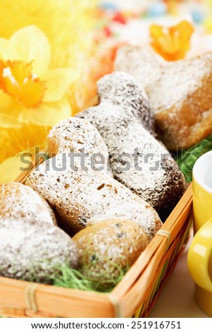 Easter pastry, Easter lambs with icing sugar in basket, daffodils