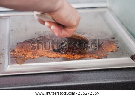 Man cleaning grill