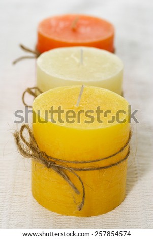 Three candles with bows of string