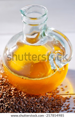 Bottle of flaxseed oil with flax seeds