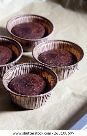 Chocolate cup cake in baking dish on baking paper and baking tray