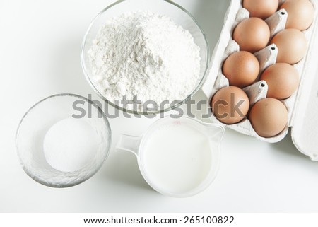 Preparing pancakes, eggs, milk, sugar and flour