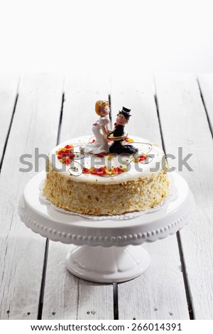 Wine cream cake, wedding cake with figurines, bride and groom