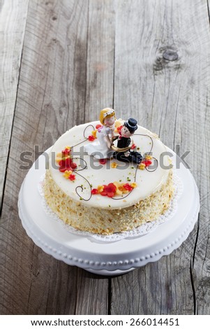 Wine cream cake, wedding cake with figurines, bride and groom