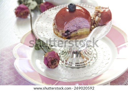 Small biscuit cake with blueberry cream, blueberry and cake glaze