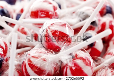 Pile of colorful lollipops wrapped in plastic foil