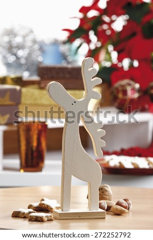 Christmas decoration, wooden elk figurine and cookies on table