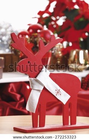 Christmas decoration, Wooden elk figurine with white bow, close-up