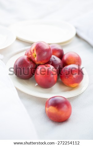 Pile of nectarines on paper plate