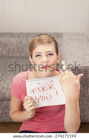 Young woman with notepad, fuck you, giving the finger