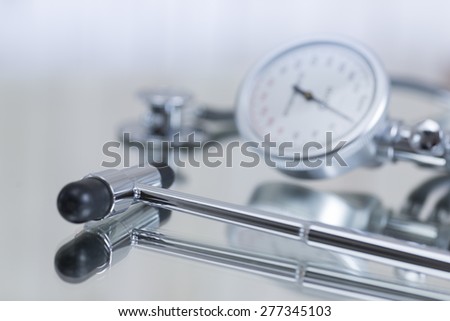 Blood pressure gauge and stethoscope and reflex hammer