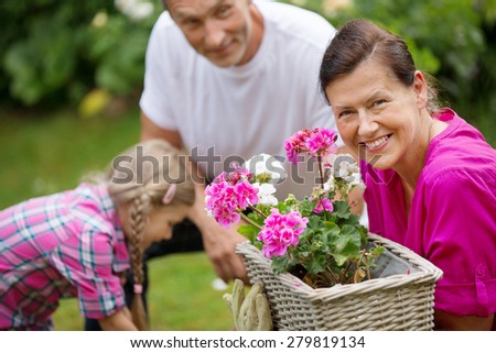 Family watering flowers in flower box