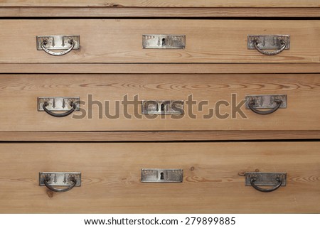 Wood drawers of old chest with metal fittings