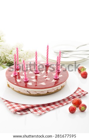 Strawberry-cream cake with birthday candles
