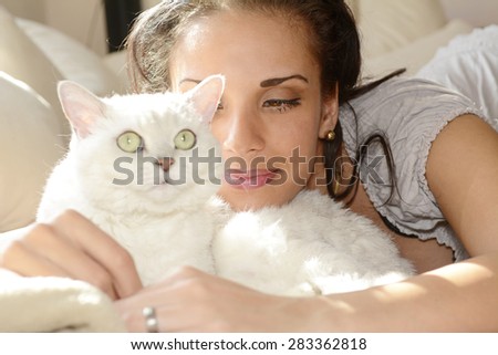 Young woman with white cat