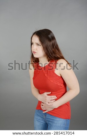 Young woman having tummy ache, cramps