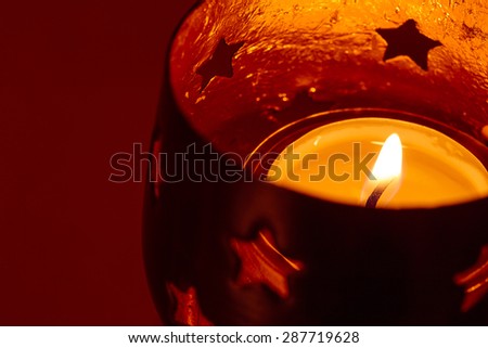Burning candle, tea light holder with stars
