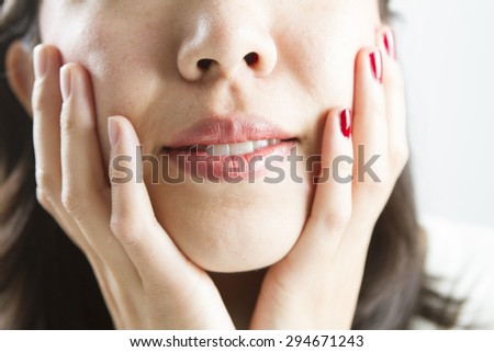 Asian woman with one hand red nail polish, one without