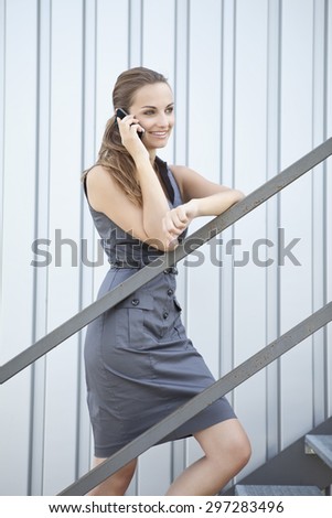 Germany,Bavaria,Young woman on phone,smiling