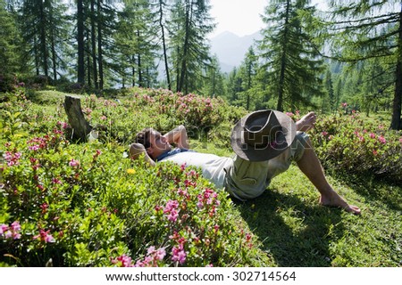 Austria,Salzburg Country,Man relaxing on alpine pasture on mountains of Niedere Tauern
