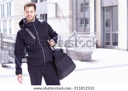 Young man wearing sports wear and bag, Madgeburg, Germany