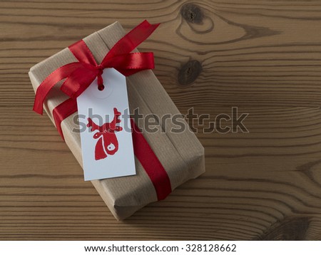 Christmas present with gift tag, printed, red ribbon
