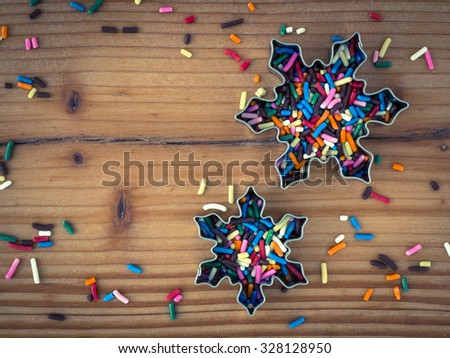 Pastry cutters with sugar granules on wood