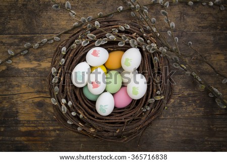Easter decoration, Easter eggs, twigs on wood