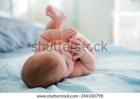 Baby plays with own feet