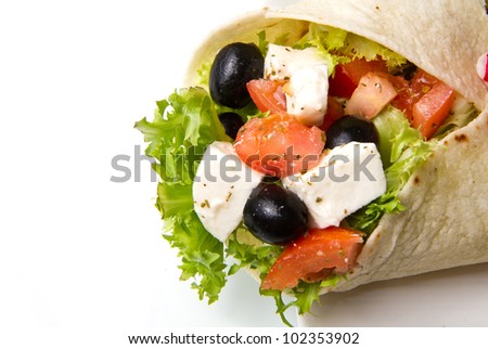 vegetarian piadina with fresh salad, tomatoes, olives and mozzarella cheese