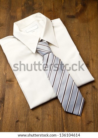 New white man's shirt and tie isolated on wood
