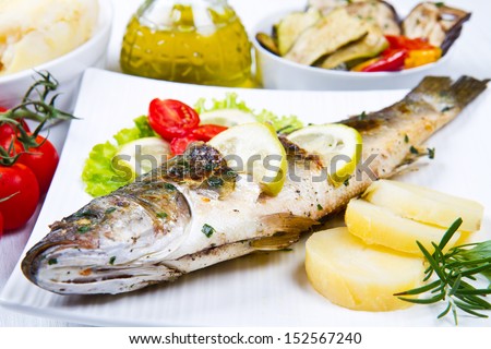 fish, sea bass grilled with lemon ,salad and potatoes