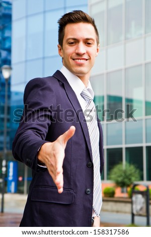 Happy smiling business man giving hand for handshake